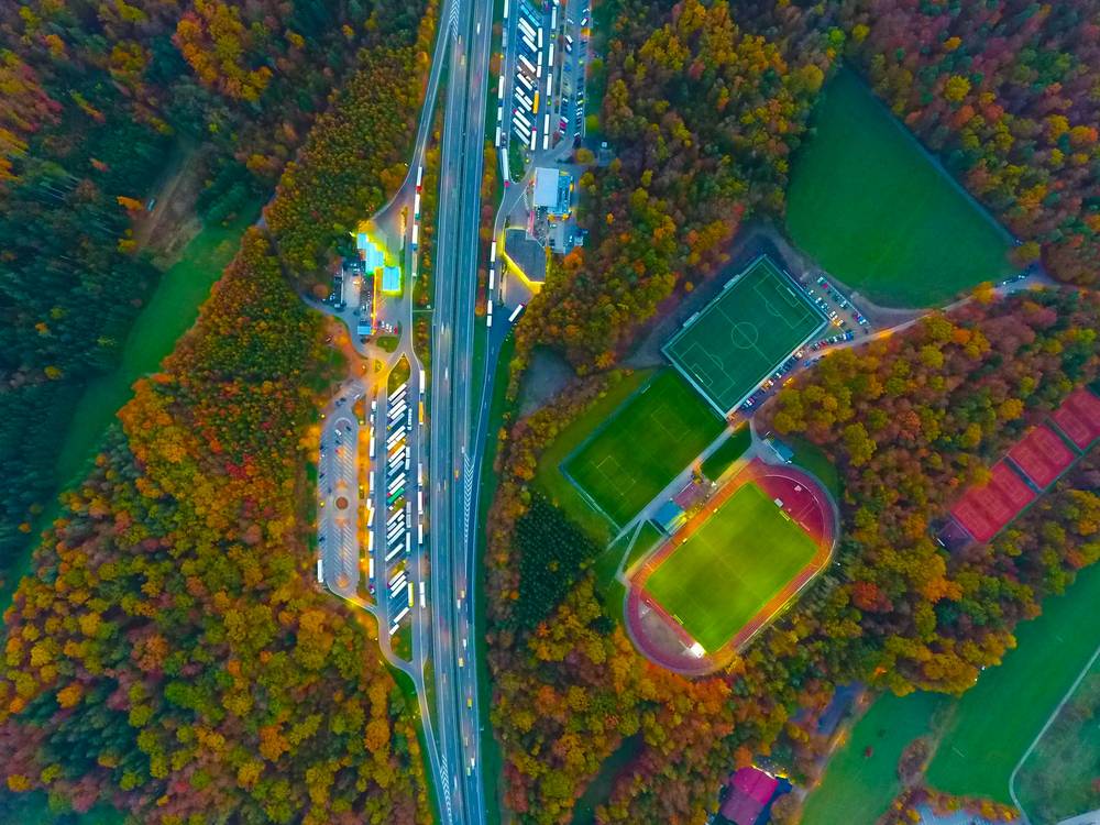 Multi-feature autumn aerial: roads, fields, structures and canopy resolved in a single frame
